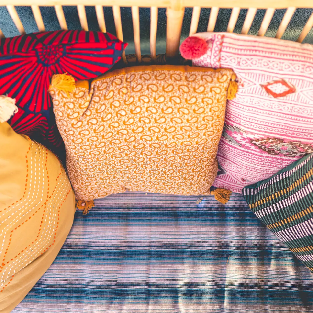 A corner of rattan armchairs and a woven table under the jute canopy