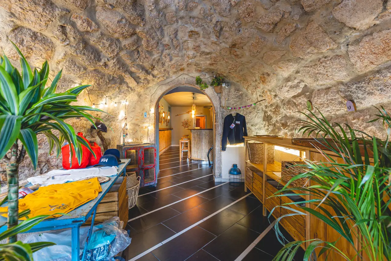 The stone room at the back of the bar, a vaulted rough stone ceiling and potted plants